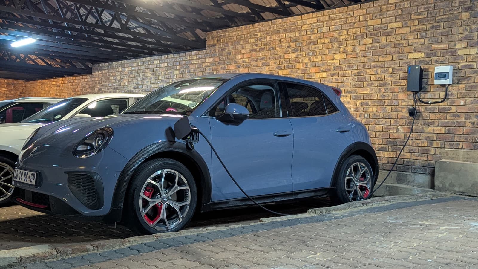 EV charging from a wall-mounted TeltoCharge in a carport